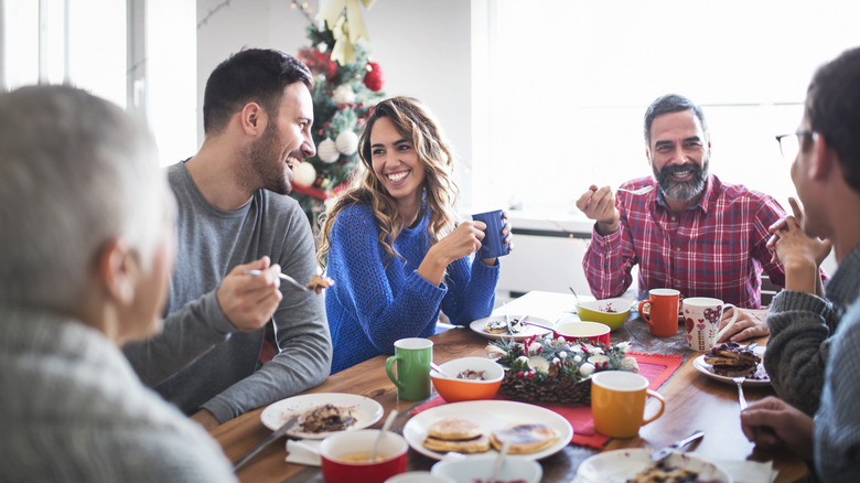 Couple looking at each other at family table