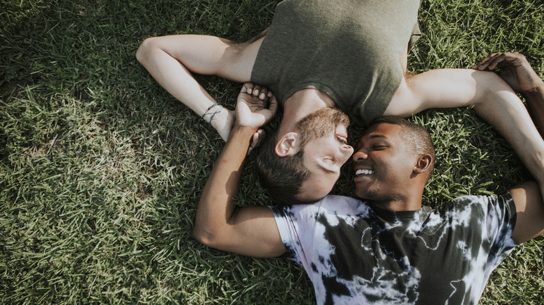 Gay couple lying together on the grass