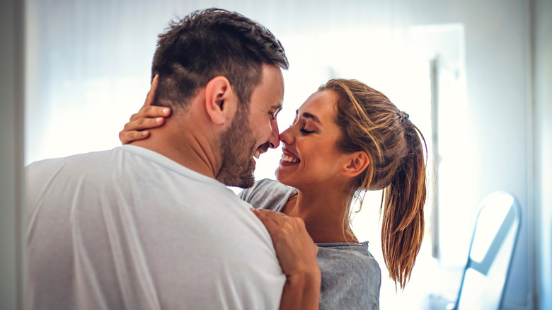 Couple holds each other in close embrace