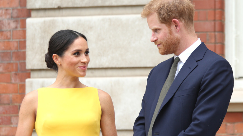 Meghan Markle looks knowingly at Prince Harry