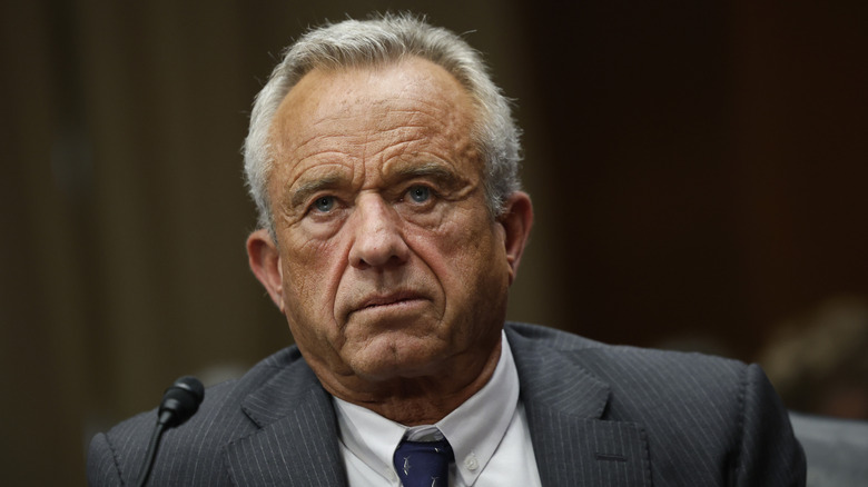 RFK Jr. sits in front of a microphone at the hearing for HHS Secretary