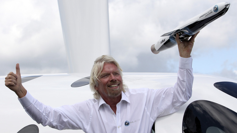 Richard Branson posing with a rocket