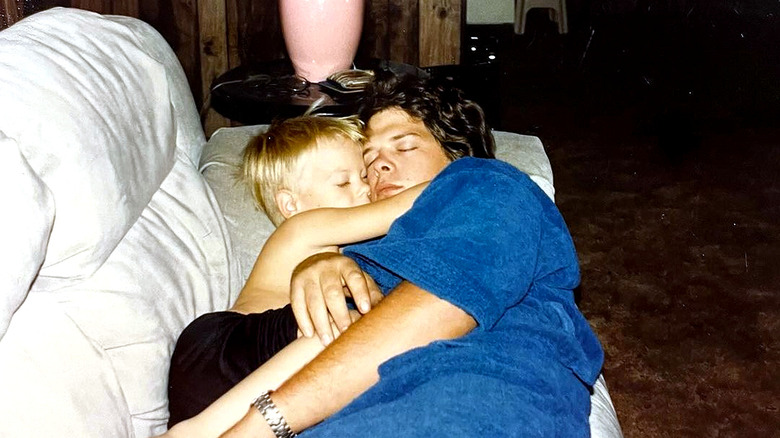 A younger Rick Harrison snoozing on the couch with Adam