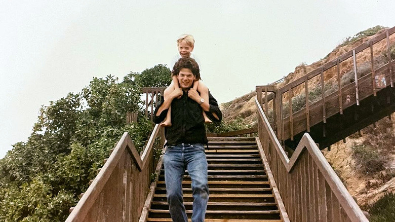 A younger Rick Harrison with Adam on his shoulders