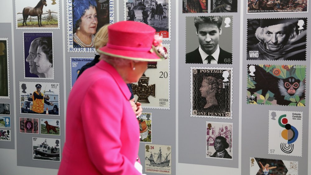 Queen Elizabeth II viewing stamps