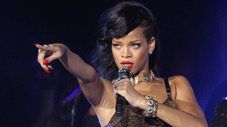 Rihanna onstage pointing to audience