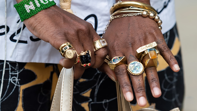 Hand showing off various rings on different fingers