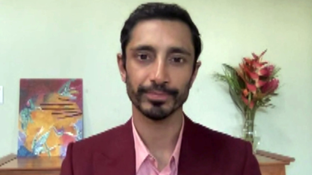 Riz Ahmed on video call maroon jacket