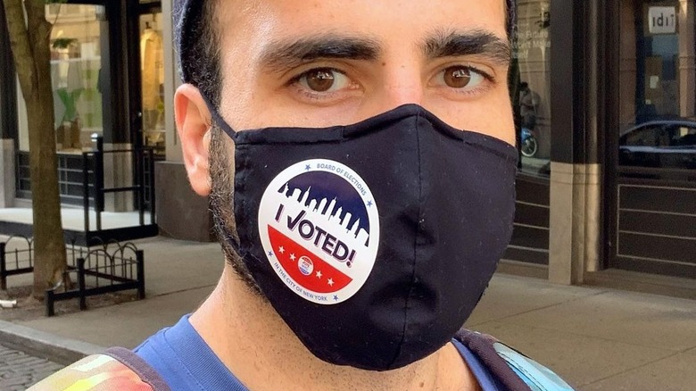 Rob Anderson wearing a black mask with an "I voted!" sticker