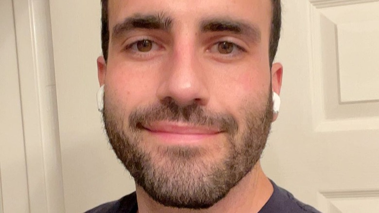 Rob Anderson smiling wearing earbuds