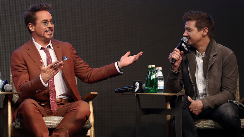 Robert Downey Jr. and Jeremy Renner speaking onstage