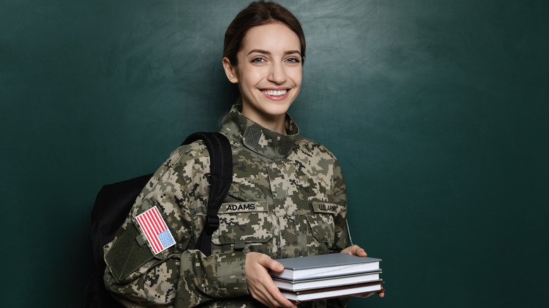 Military woman holding books