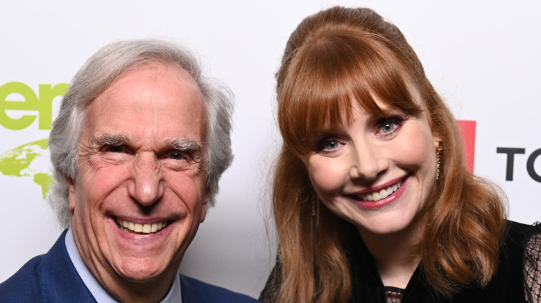 Henry Winkler and Bryce Dallas Howard smiling at an event