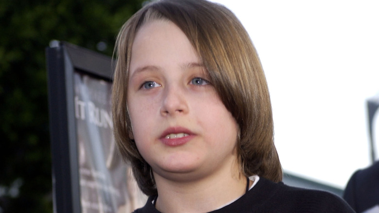 Young Rory Culkin with long hair