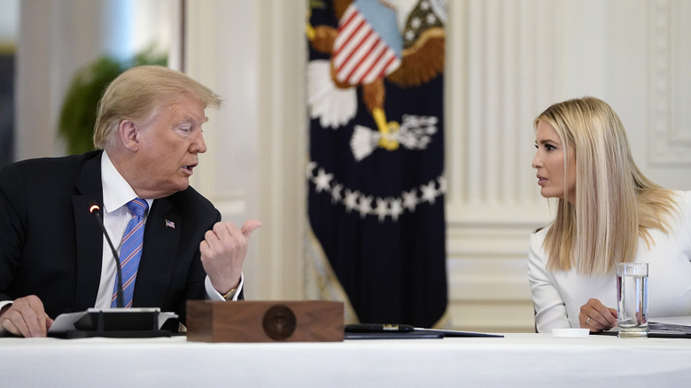 Donald and Ivanka Trump talking across table