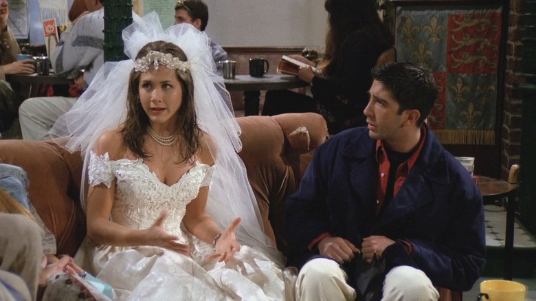 Rachel in a wedding dress next to Ross