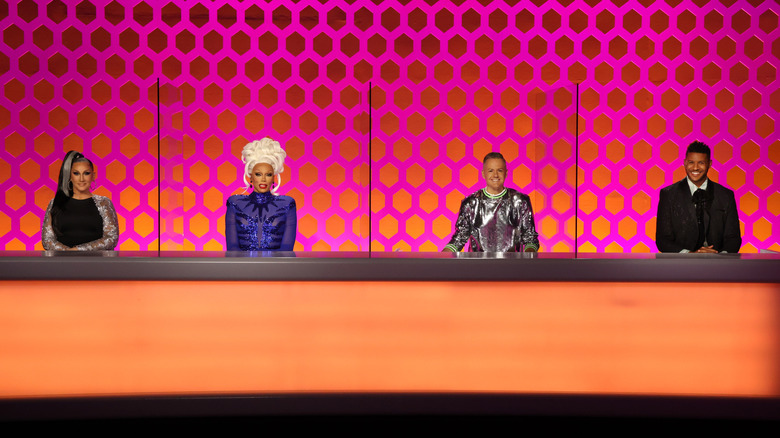 Judges of RuPaul's Drag Race smiling at table