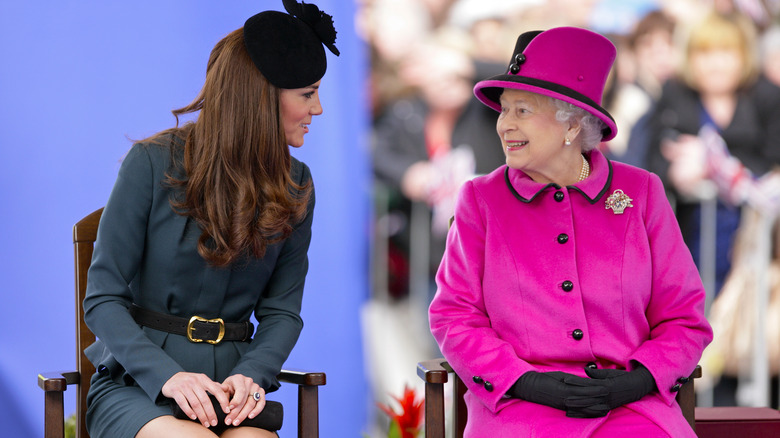 Kate Middleton and Queen Elizabeth talking and smiling at each other 