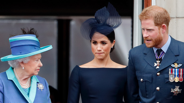 The queen, Meghan Markle and Prince Harry on balcony