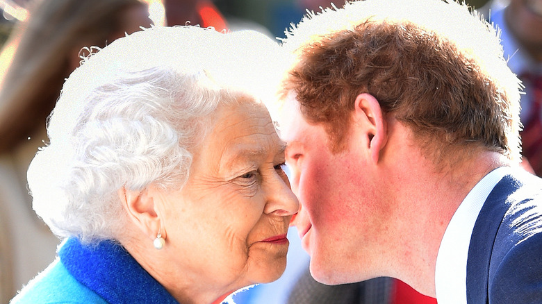 Prince Harry leans over to the queen