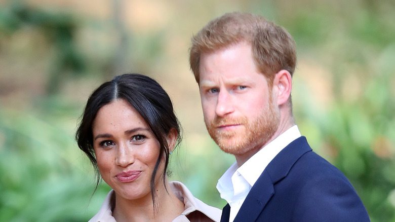 Meghan Markle and Prince Harry pose in a garden