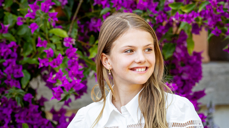 Princess Estelle of Sweden against pink flowers