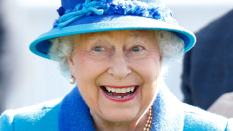 Queen Elizabeth smiling with a gleam in her eye