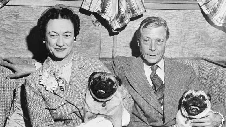 Wallis Simpson posing with King Edward VIII and their two pugs