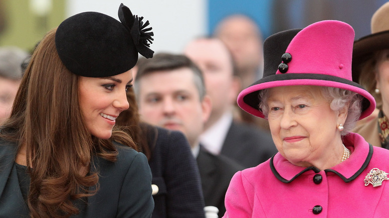 Kate Middleton and the queen sit together