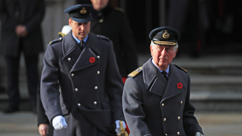 King Charles and Prince William walking solemnly