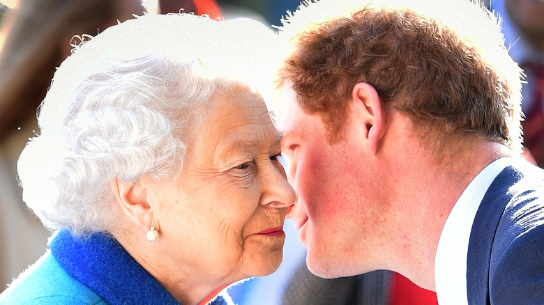 Prince Harry leaning in close to Queen Elizabeth