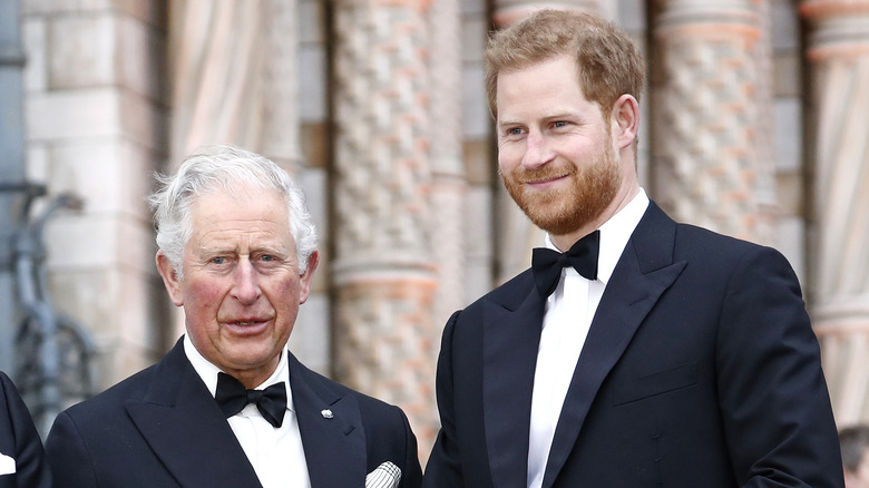 Prince Charles and Prince Harry pose for a photo. 