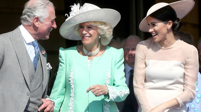 King Charles Queen Camilla Meghan smiling