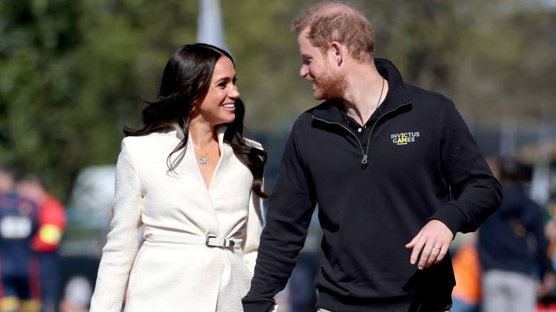 Meghan Markle and Prince Harry smiling at each other