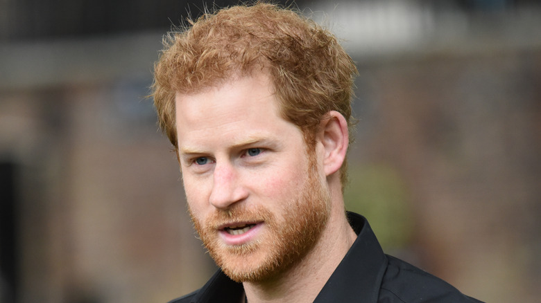 Prince Harry wears a black shirt