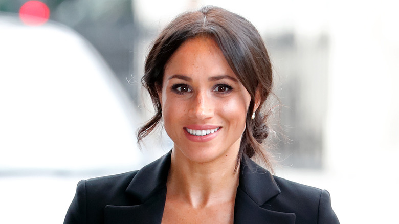 Meghan Markle smiles for a photo 