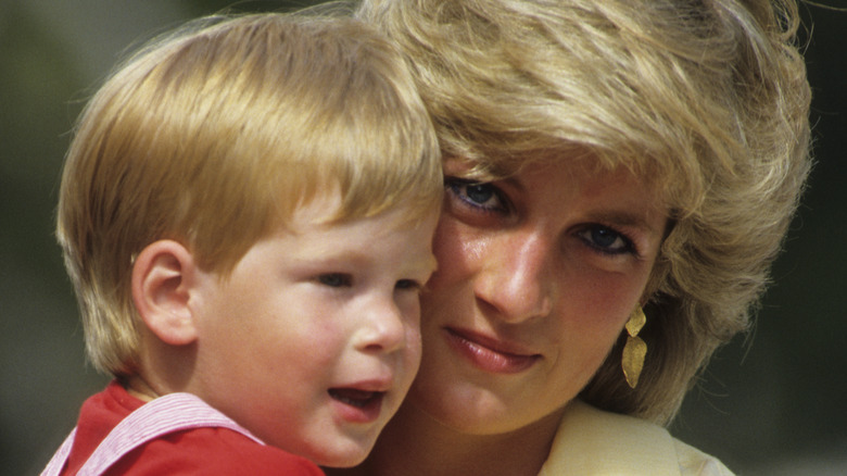 Princess Diana cuddles a young Prince Harry