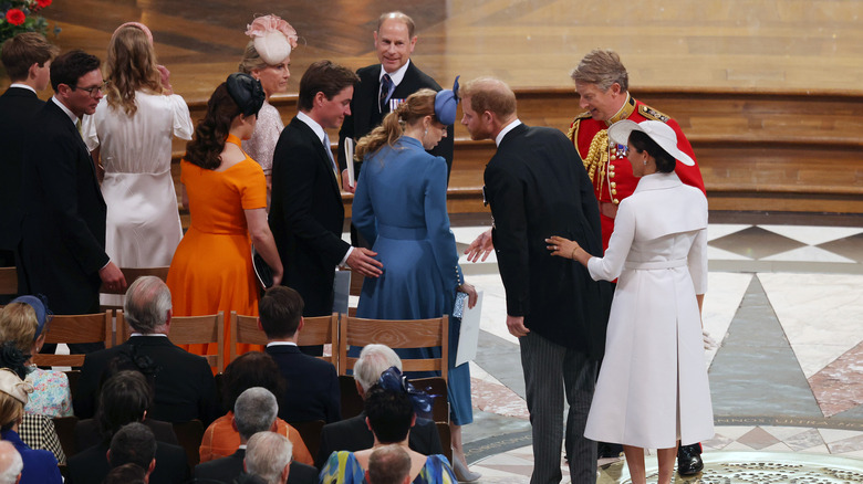 Harry and Meghan sitting with Eugenie and Beatrice