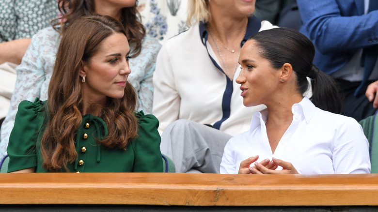 Kate Middleton and Meghan Markle share a moment together. 