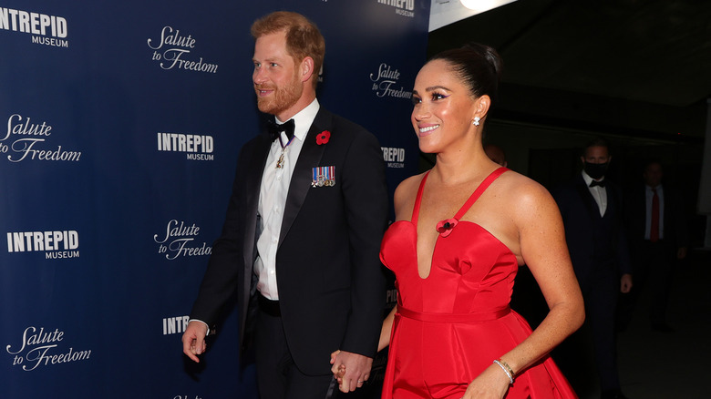 Prince Harry and Meghan Markle walking at a red carpet event