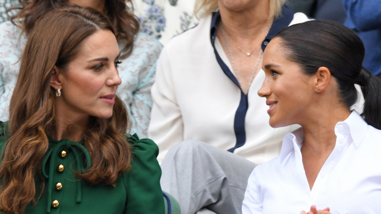 Kate Middleton and Meghan Markle at an event. 