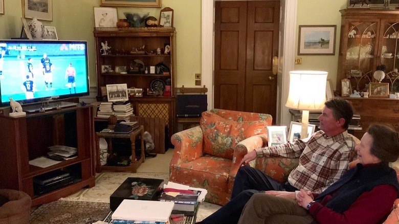 Princess Anne and Sir Tim Laurence watching TV at home