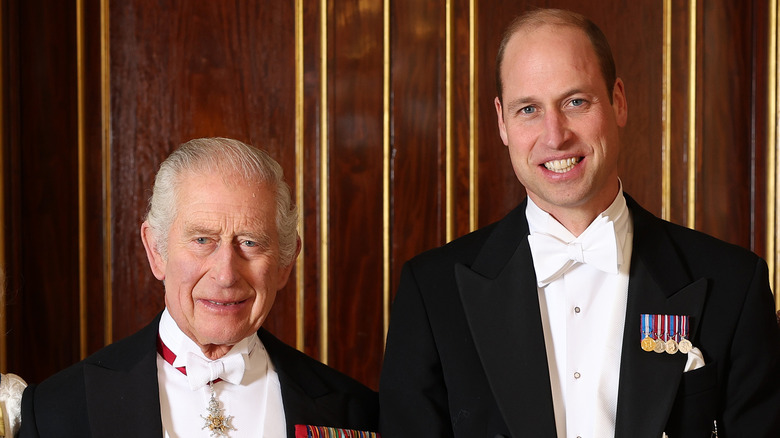 Prince William and King Charles posing at an event