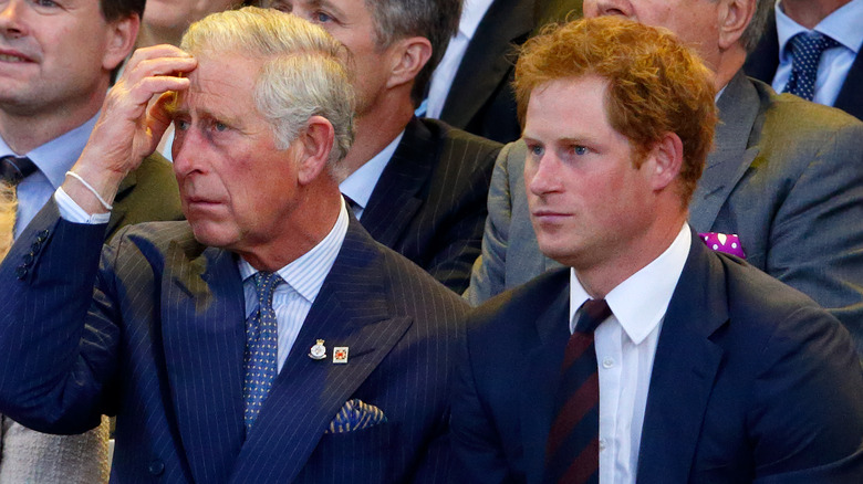 Prince Harry looks worried next to King Charles