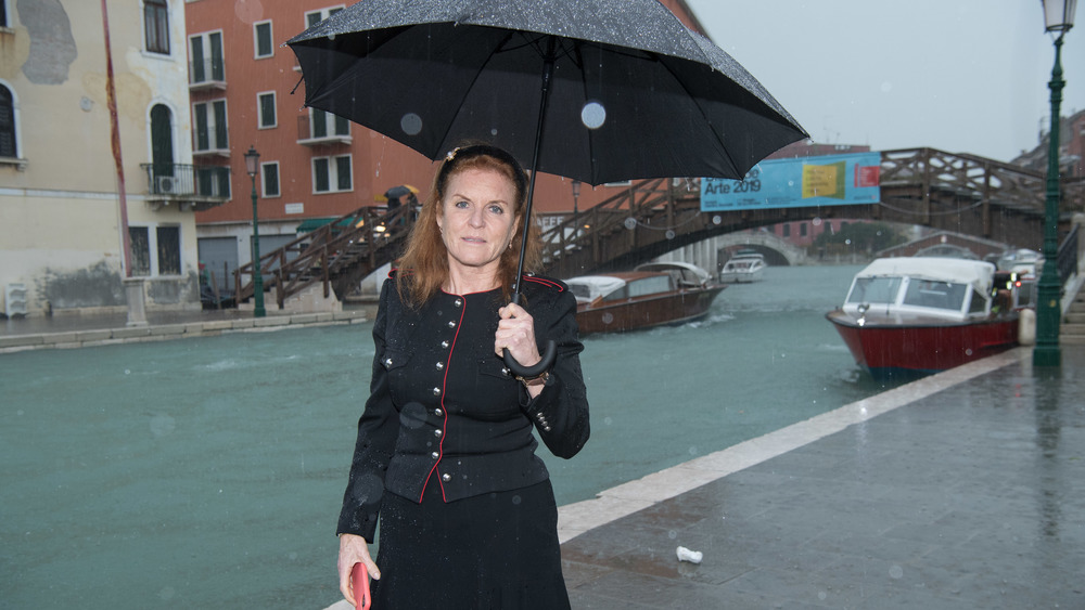 Sarah Ferguson standing in the rain