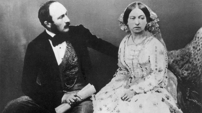 Queen Victoria sitting down with Prince Albert