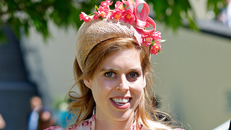 Princess Beatrice smiling in a floral hat