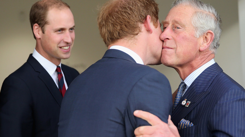 Prince William watching as Prince Harry and King Charles III hug