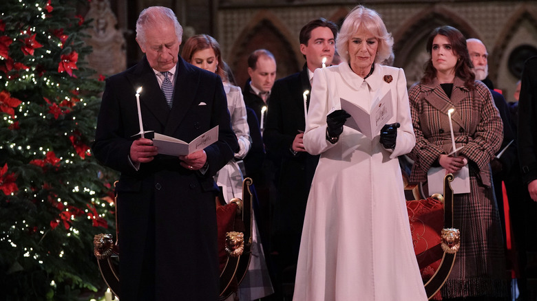 King Charles and Queen Camilla praying 