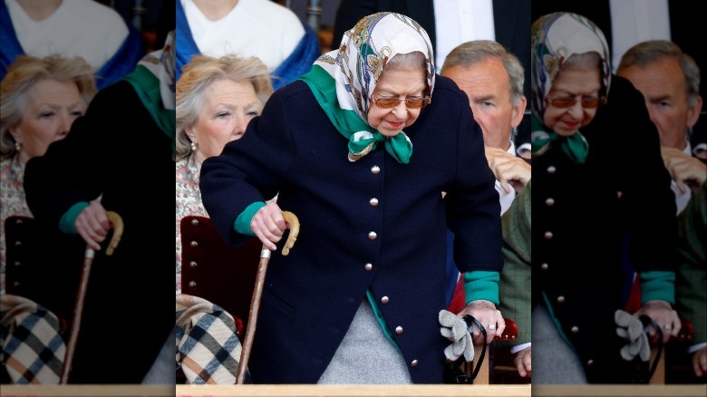 The Queen holding a cane